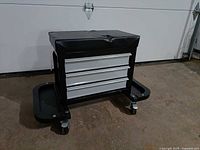 Front view showing three drawers and casters