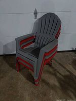 Four plastic Adirondack chairs stacked together showing overall appearance and colors