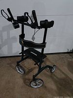 Full view of dark green Propel Mobility rollator walker showing wheels, seat, forearm supports, and brakes.