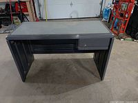 Front view of dark grey plastic resin desk with drawer