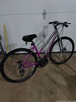 Full side view of Schwinn purple/silver hybrid bicycle