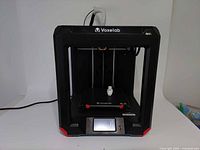Front view of Voxelab Aries 3D printer showing frame, print bed, touchscreen