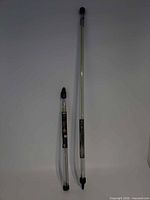 Two glow rod sets in tubes, sizes compared