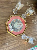 Overall lot showing framed plate and three figurines