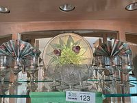 Front view showing all eight crystal glasses, round thistle glass plate, two floral napkins