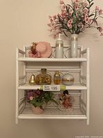 Full view of white wicker shelf and all included decorative items