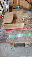Cardboard box labeled "2 1/4 common brite" nails, showing condition and packaging