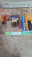 Group shot of tester in package, wire stripper kit, and test light