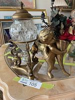 Dish and cherub together on table