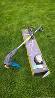 Full view of Yardworks trimmer beside box and replacement line