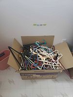 full view of cardboard box with mixed hangers