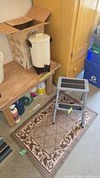 Coffee percolator in box, step stool and patterned floor mat