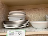 stack showing dinner plates and bowls on shelf