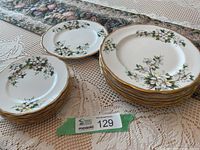 Stack of 7 dinner plates, stack of 8 side plates, single luncheon plate displayed