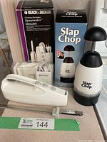 Full lot view showing electric knife set, Slap Chop unit and both boxes