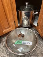 Wok lid and stock pot in cabinet