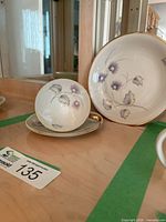 Cup, saucer and plate displayed together showing pattern and trim