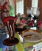 Lot overview showing pottery deer, porcelain roses, Saji dish, candle holder