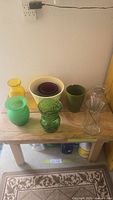 Group of assorted vases and planters on wooden bench