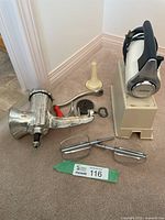 Overall view of meat grinder, Sunbeam mixer on stand, beaters and plastic cone