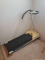 Full view of York Fitness TM/300 treadmill folded against wall