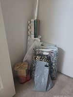 Overall view of wrapping paper rolls, gift boxes and bags in corner