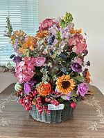 Front view of entire floral arrangement in wicker basket