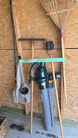 Group view of blower/vac, rakes, lawn edger and catcher bag