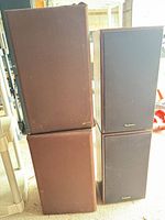 All four speakers showing two Technics with black grills and two Fidelio with brown grills