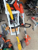 Both trimmers leaning against shelving