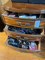 three drawers filled with cables, adapters and small electronics