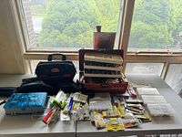 Overall view showing Fenwick box, Rapala bag, blue box, clear organizers and packaged tackle on table