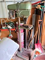 Full view of the floor drill press showing base, column, head and surroundings