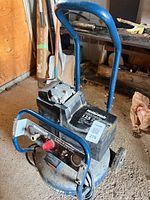 Mastercraft portable electric air compressor showing handle, wheels, tank, control panel and motor