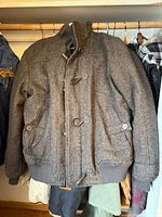 Grey wool-blend toggle front bomber jacket on hanger