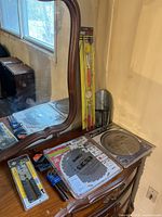 All items on dresser: two saw blades, pick-up tool set, tile pliers, Allen keys, metal scoop