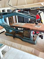 Full view of scroll saw right side, showing frame, table and cord