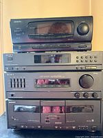 Front view of full four-component stack showing Onkyo unit, Sony tuner, Sony receiver/equalizer, Sony cassette deck