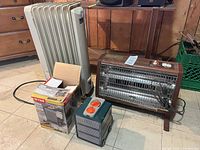 Three heaters side by side: oil-filled radiator, boxed area, cube heater, Sears radiant heater