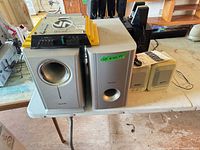 Front view showing Panasonic speakers, beige computer speakers, car amplifier on top