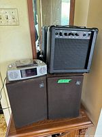 Stack showing stereo on JBL speakers beside guitar amp