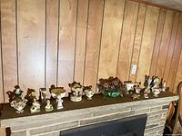 Full mantel view showing quantity and variety of figurines, compotes, music box