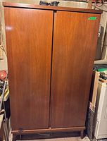 Front view of closed walnut finish wardrobe