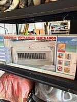 Front of boxed Holmes window fan showing overall packaging