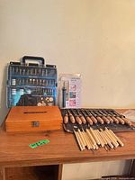 Overall lot with router bit box, rotary accessory kit, packaged Dremel bit, and array of carving chisels