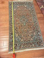 full view of rug with tape showing length