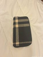 Front view of Burberry plaid wool wallet
