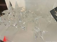 Group of clear acrylic star ornaments on shelf