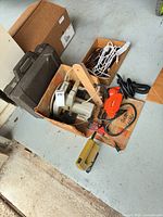 Overview of box containing tools, case, cords