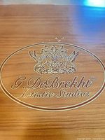 wooden presentation box lid with G. DeBrekht Artistic Studios logo